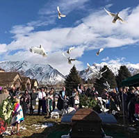 funeral with snow capped mountains